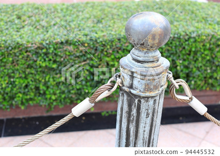 pole with metal restraining rope. Barrier, enclosed VIP area, protected entrance, private event,  restrict area barricade pole. 94445532