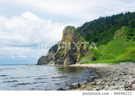 coastal landscape, beautiful lava rocks on the green coast of Kunashir island 94446222
