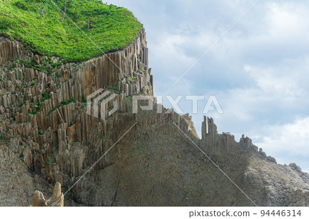 amazing landscape of columnar volcanic basalt rocks on the island of Kunashir amazing landscape of columnar volcanic basalt rocks on the island of Kunashir 94446314