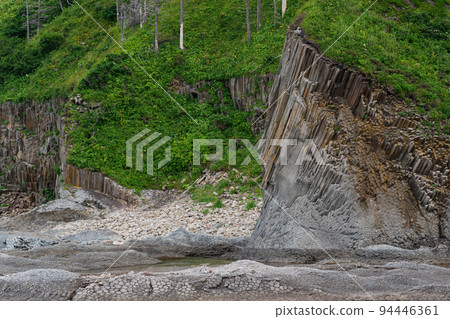 coastal landscape, beautiful wooded rocks on the green coast of Kunashir island coastal landscape, beautiful wooded rocks on the green coast of Kunashir island 94446361