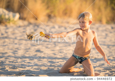 Cute joyful little boy having fun on the beach 94446972