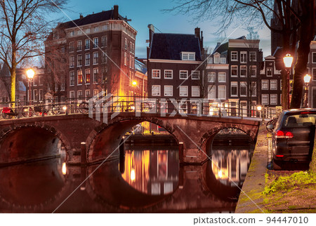 Beautiful old houses on the city waterfront of Amsterdam at sunset. 94447010