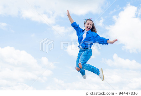 cheerful teen girl jumping high. kid jump outdoor. kid fashion and beauty. sense of freedom. portrait of energetic child girl. concept of future. happy childhood. Feeling free and happy 94447836