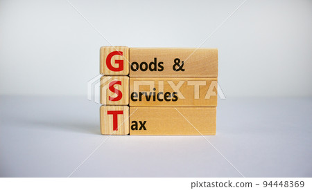 Concept words 'GST, goods and services tax' on wooden cubes and blocks on a beautiful white background. Business concept. Copy space. Concept words 'GST, goods and services tax' on wooden cubes and blocks on a beautiful white background. Business concept. Copy space. 94448369