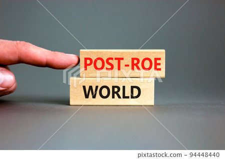 Roe vs Wade post-Roe world symbol. Concept words Post-Roe world on wooden blocks on a beautiful grey background. Businessman hand. Business and Roe vs Wade post-Roe world concept. Copy space. Roe vs Wade post-Roe world symbol. Concept words Post-Roe world on wooden blocks on a beautiful grey background. Businessman hand. Business and Roe vs Wade post-Roe world concept. Copy space. 94448440