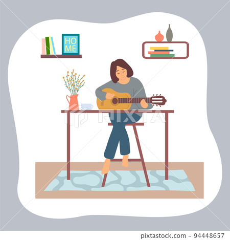Young brunette girl sitting at table and playing guitar, compose music, enjoy of hobby leisure time 94448657