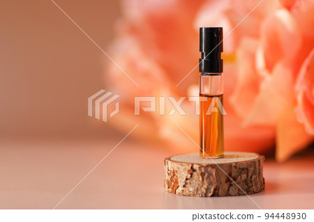 Perfume sample with orange liquid on woooden Stock Photo