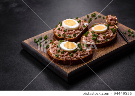 Delicious healthy sandwich with tuna, croutons, boiled egg, herbs and butter Delicious healthy sandwich with tuna, croutons, boiled egg, herbs and butter 94449536