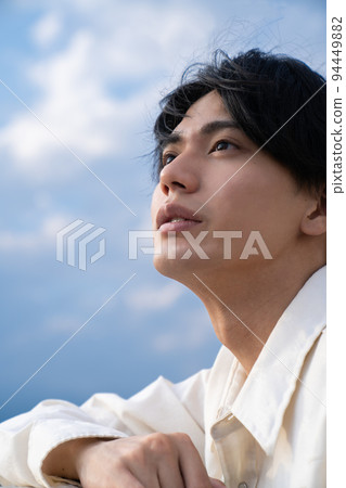 portrait of a man looking up at the sky portrait of a man looking up at the sky 94449882