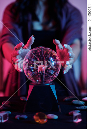Closeup image of fortune teller gazing into crystal ball and seeing fortune Closeup image of fortune teller gazing into crystal ball and seeing fortune 94450084