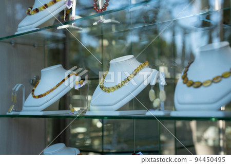 Beautiful amber necklaces in a showcase. Beautiful amber necklaces in a showcase. 94450495
