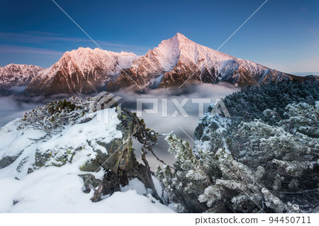 Winter landscape with mountain Krivan in High Tatras illuminated by morning sun 94450711