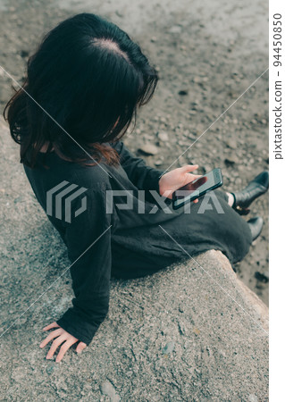 woman standing on the riverbed 94450850