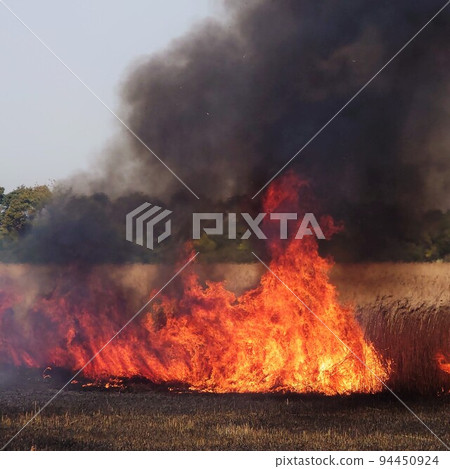 Rising black smoke and big fire Rising black smoke and big fire 94450924