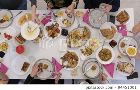 Top view of muslim family having Iftar during Ramadan holy month Top view of muslim family having Iftar during Ramadan holy month 94451001