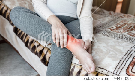 Pregnancy pain leg woman. Pregnant girl have leg disease, ankle pain doing health massage exercise. Foot swelling during pregnancy. 94451092