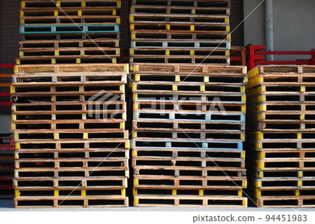Pallets stacked in distribution warehouse Pallets stacked in distribution warehouse 94451983