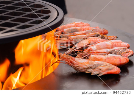 Process of cooking fresh red langoustine shrimps, prawns on grill - street food 94452783
