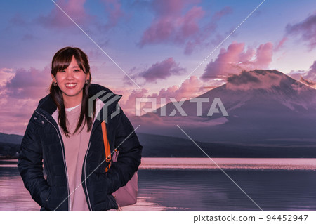 Woman enjoying Mt.Fuji at blue hour at Lake Yamanaka Woman enjoying Mt.Fuji at blue hour at Lake Yamanaka 94452947
