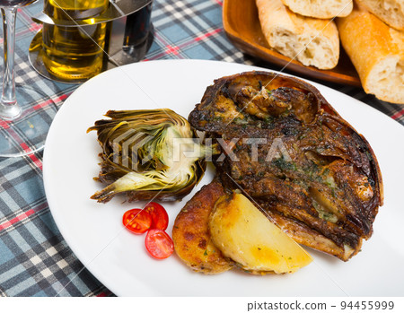 Cabeza de cordero - spanish dish. Lamb head with artichoke, tomatoes and potatoes Cabeza de cordero - spanish dish. Lamb head with artichoke, tomatoes and potatoes 94455999