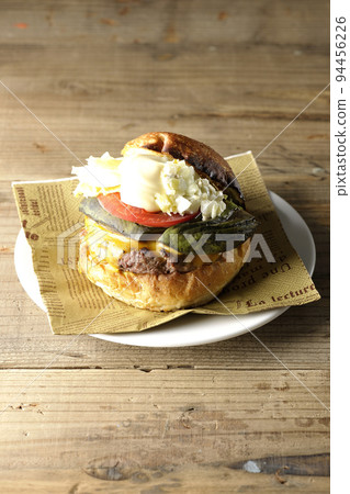Avocado cheeseburger on a paper napkin 94456226