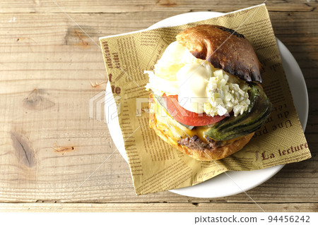Avocado cheeseburger on a paper napkin Avocado cheeseburger on a paper napkin 94456242