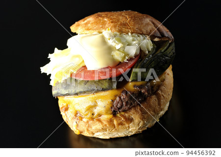 Avocado cheeseburger shot on black background 94456392