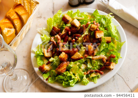 Lettuce, crouton, lardon salad on plate 94456411