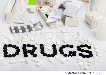 Word DRUGS lined with tablets 94456439