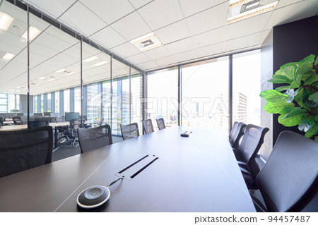 Glass-enclosed conference room with bright light Office interior view Interior business image 94457487
