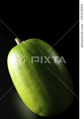 Shoot a winter melon against a black background Shoot a winter melon against a black background 94459004