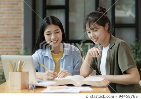 Young asian students campus helps friend catching up and learning. Young asian students campus helps friend catching up and learning. 94459769