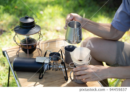 Hand dripping coffee outdoors 94459837