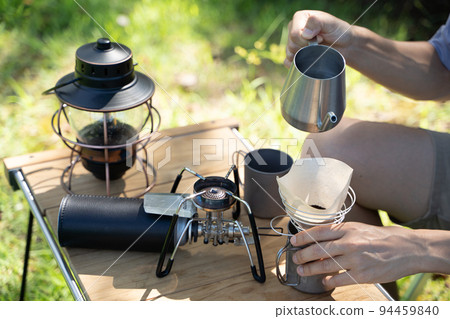 Hand dripping coffee outdoors 94459840