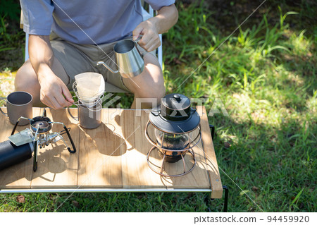 Hand dripping coffee outdoors 94459920