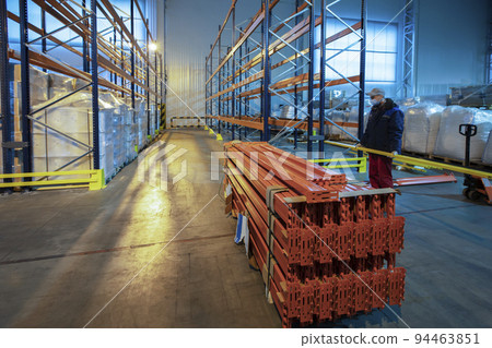Warehouse premises of a factory or workshop with metal shelves. Warehouse premises of a factory or workshop with metal shelves. 94463851