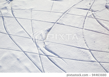 Skate tracks on ice with snowy snow. Winter background. Skate tracks on ice with snowy snow. Winter background. 94463880