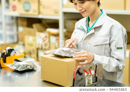 A woman preparing to ship products in the backyard A woman preparing to ship products in the backyard 94465863