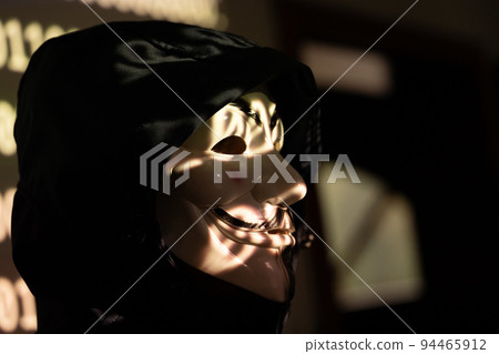 Hooded identity theft wearing an Anonymous mask Hooded identity theft wearing an Anonymous mask 94465912