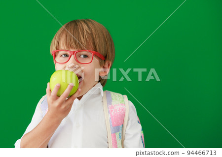 Happy child student against green chalkboard 94466713