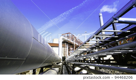 Industrial zone, Steel pipelines and valves against blue sky 94468206