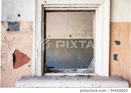 A small window inside an abandoned building A small window inside an abandoned building 94468803