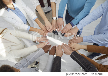 Top view multiracial team peoples outstretched hands standing in circle symbolizing inclusive Top view multiracial team peoples outstretched hands standing in circle symbolizing inclusive 94469019