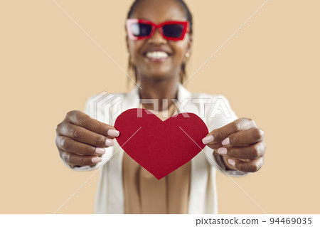 Happy black woman show red paper heart Happy black woman show red paper heart 94469035