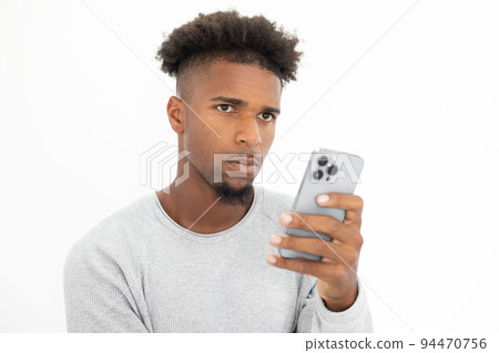 Portrait of concentrated African American man with mobile phone Portrait of concentrated African American man with mobile phone 94470756
