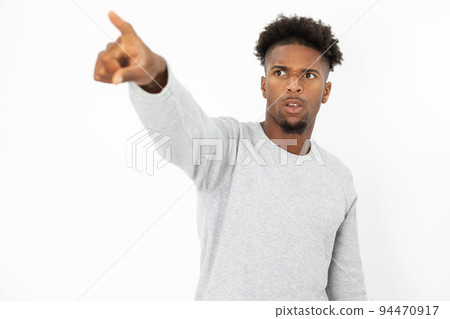 Portrait of African American man pointing at something Portrait of African American man pointing at something 94470917