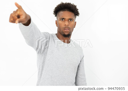 Portrait of serious African American man pointing at something 94470935