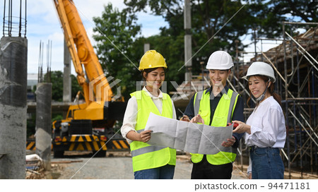 Team of specialists inspecting, discussing plan details with civil engineer at building construction site Team of specialists inspecting, discussing plan details with civil engineer at building construction site 94471181