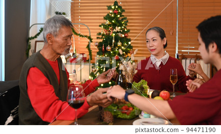 Loving family saying grace before holiday dinner. Christmas, New year, thanksgiving and celebration concept 94471190
