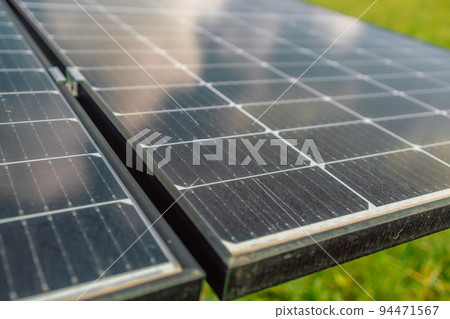 Close up on female hand touching stroking photovoltaic solar panels in sunny day, renewable clean energy power concept Close up on female hand touching stroking photovoltaic solar panels in sunny day, renewable clean energy power concept 94471567